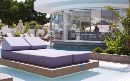 a pool with two purple mattresses on a platform in the water at Kapetanios Bay Hotel Protaras in Protaras