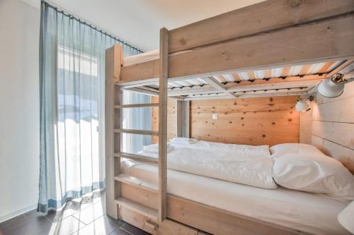 a bunk bed in a room with a window at Stella 5 in Riederalp