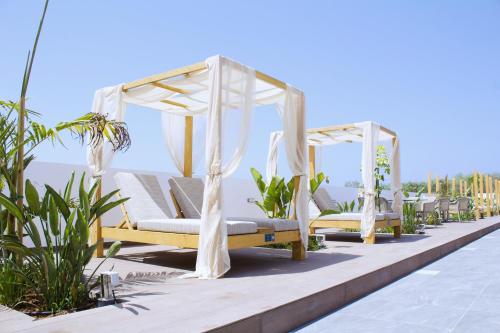 a row of beds on the roof of a resort at Kapetanios Bay Hotel Protaras in Protaras