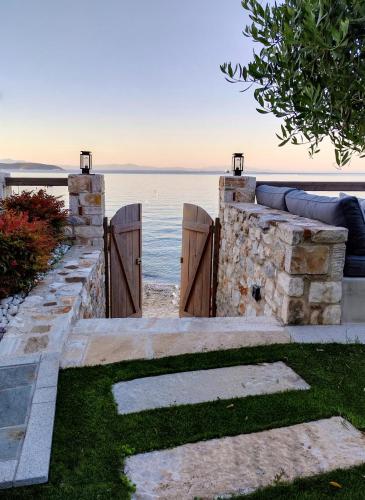 a fence with the ocean in the background at Aura di mare luxury house Thassos in Limenas