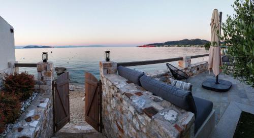a stone retaining wall with a view of the water at Aura di mare luxury house Thassos in Limenas