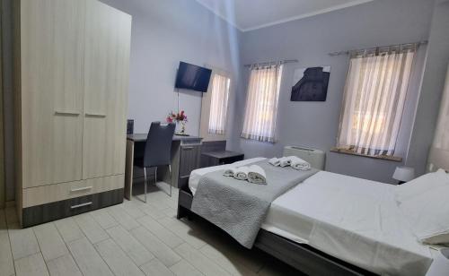 a bedroom with a bed and a desk with a computer at Residenza Atena Tropea in Tropea