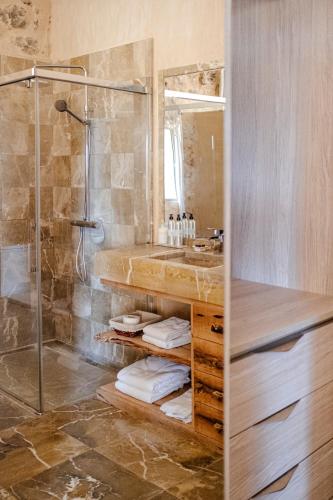 a bathroom with a shower and a sink at Finca Gomera - Agroturismo Hotel in Cala Pi