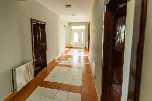 an empty hallway with a tile floor in a house at VILA ODISEA in Baile Felix