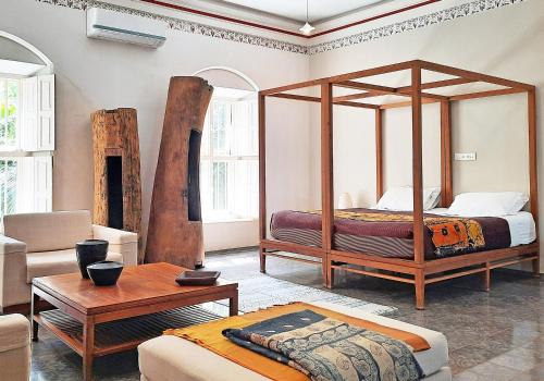 A bed or beds in a room at Saratha Vilas Chettinad