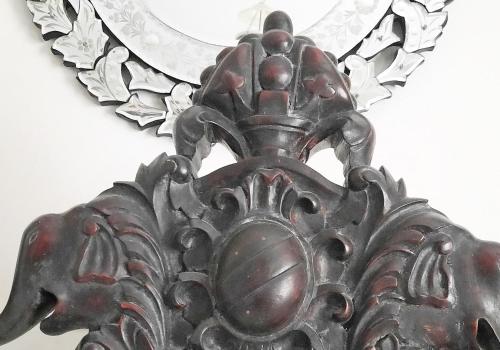 a close up of a metal mask on a wall at Saratha Vilas Chettinad in Kānādukāttān
