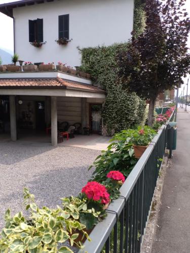 a fence with flowers and plants in front of a building at Albergo Sangalli in Boario Terme
