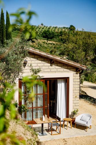 a small house with a table and chairs in front of it at Antichi Casali di Charme in Orvieto