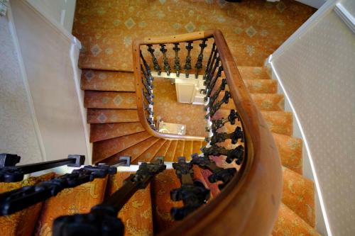 a staircase with a mirror in a stair case at Kingsway Guest House in Edinburgh