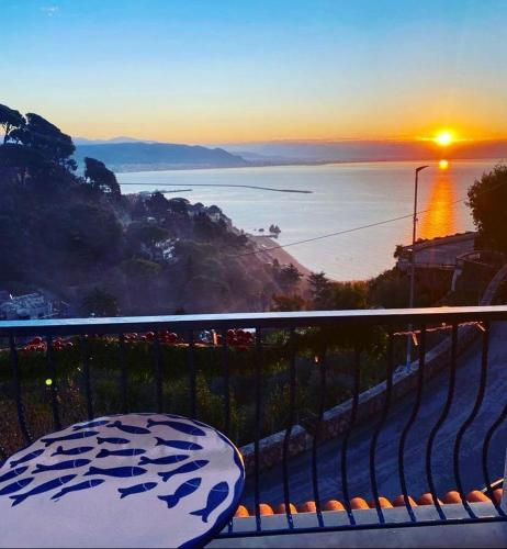 a view of the ocean at sunset from a balcony at Residence Villa Giordano sea view Amalfi Coast in Vietri sul Mare