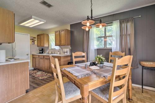 a kitchen and dining room with a wooden table and chairs at Docks and Balcony Peaceful River Abode in Dunnellon in Dunnellon