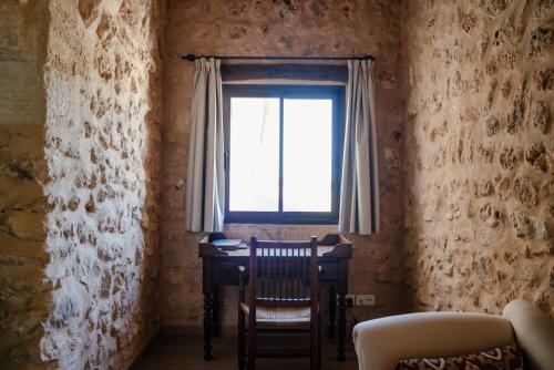 a dining room with a table and a window at Finca Gomera - Agroturismo Hotel in Cala Pi