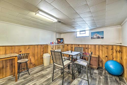 a classroom with a table and chairs and a whiteboard at Cozy Retreat with Yard about 2 Mi to Lake Michigan! in Muskegon