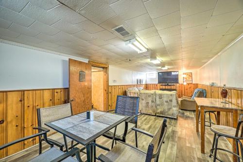 a conference room with tables and chairs and a whiteboard at Cozy Retreat with Yard about 2 Mi to Lake Michigan! in Muskegon