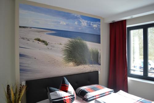 a living room with a painting of a beach at Apartment mit Meeresblick in Binz