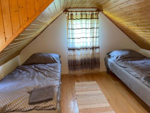 A bed or beds in a room at Füge Vendégház