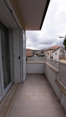 an empty balcony with a view of a city at Aria di Sale in Martinsicuro