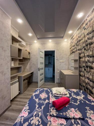 a bedroom with a bed with a red pillow on it at Apartament DeLux Sea View in Batumi