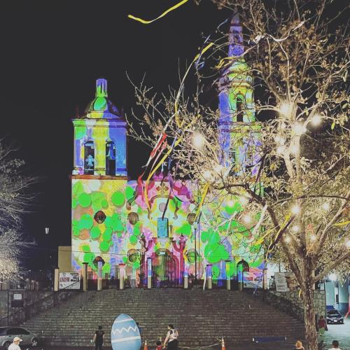 a large building with colorful lights in front of it at Casa Praxedis in Santiago