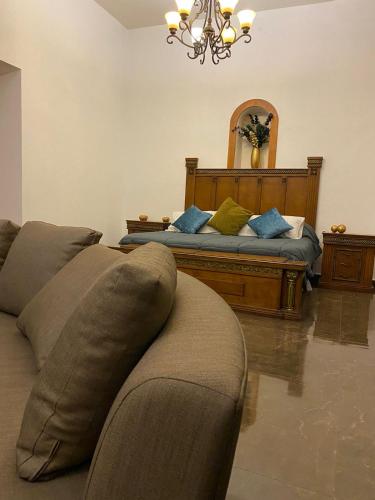 a living room with a couch and a bed at Casa Praxedis in Santiago