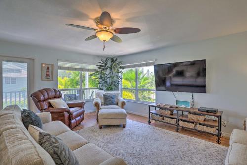 a living room with a couch and a flat screen tv at Covered Deck and Bay Views Bradenton Beach Abode! in Bradenton Beach