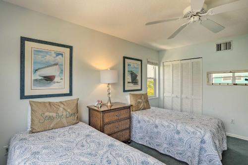 a bedroom with two beds and a ceiling fan at Covered Deck and Bay Views Bradenton Beach Abode! in Bradenton Beach
