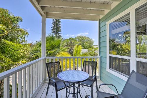 a patio with a table and chairs on a porch at Covered Deck and Bay Views Bradenton Beach Abode! in Bradenton Beach