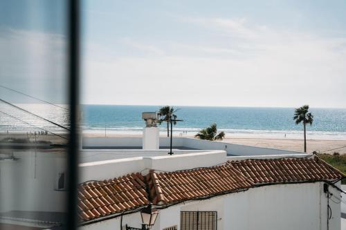 a view of the beach from a building at Hostal Brisas de Conil in Conil de la Frontera