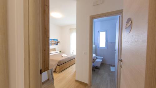 a bedroom with a bed and a room with a bathroom at Aria di Sale in Martinsicuro