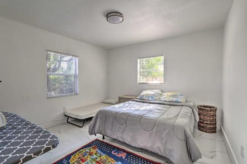 a bedroom with a bed and a chair and two windows at Pet-Friendly Miami House about 8 Mi to Beaches! in Miami