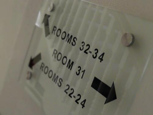 a close up of a white door with the numbers on it at Henley House Hotel in London