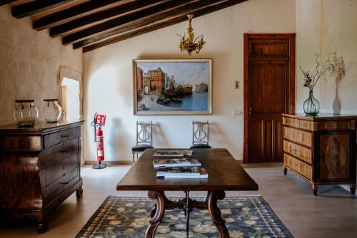 a living room with a table and a dresser at Finca Gomera - Agroturismo Hotel in Cala Pi