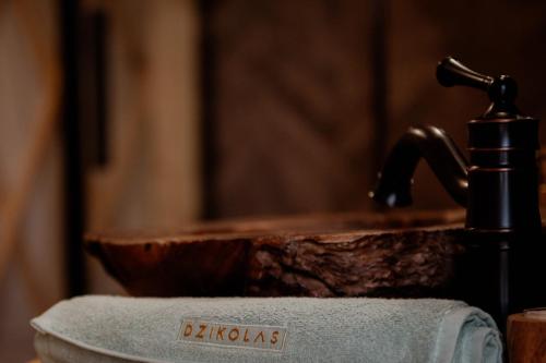 a close up of a bathroom sink in front of a mirror at Jurty z widokiem, prywatna balia- DZIKOLAS GLAMPING in Krasnobród