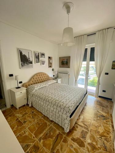 a bedroom with a bed and a large window at Casa Bonelli in Sestri Levante