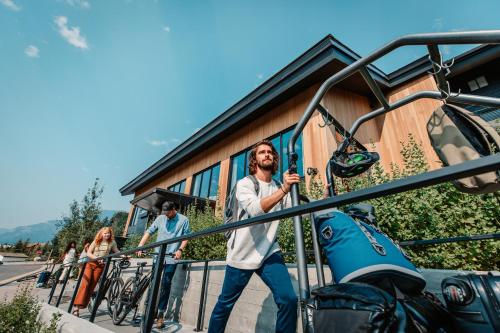 a man walking down the stairs next to a bike at Gravity Haus Jackson Hole in Teton Village