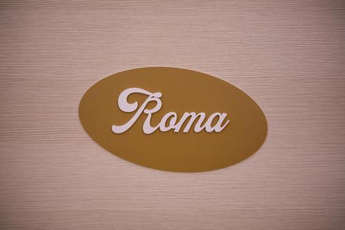 a brown circle with the word roma written on it at Aria di Sale in Martinsicuro