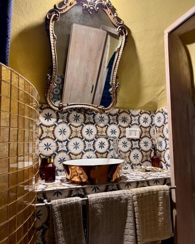 a bathroom with a sink and a mirror at Il Saraceno B&B in Carovigno