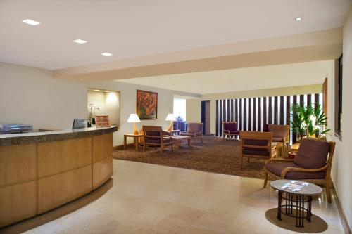 a lobby of a hotel with chairs and tables at Fiesta Americana Reforma in Mexico City