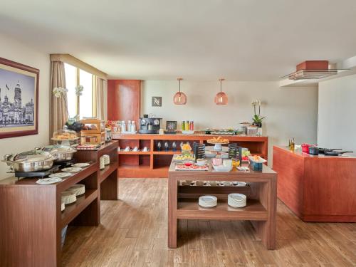 a kitchen with tables with food on it at Fiesta Americana Reforma in Mexico City