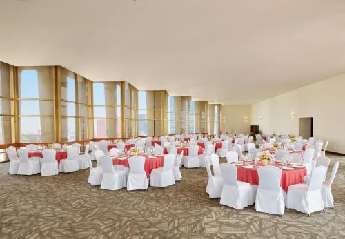 a banquet hall with white tables and white chairs at Fiesta Americana Reforma in Mexico City