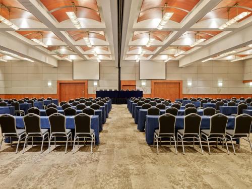a large room with chairs and tables in it at Fiesta Americana Reforma in Mexico City