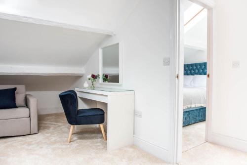 a room with a desk and a chair and a bed at Monterey Residence - Stunning, Duplex Apartment in the Heart of Kendal in Kendal