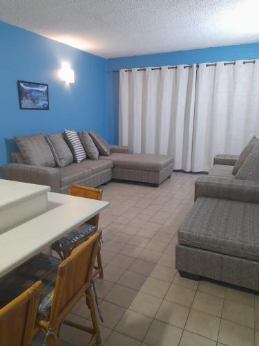 a living room with a couch and a table at Stella Maris 194 Amazimtoti Self Catering accommodation in Amanzimtoti