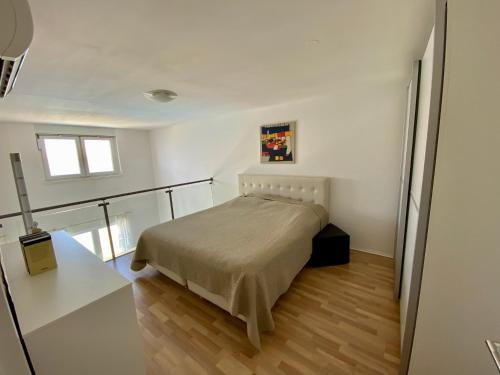 a bedroom with a bed in a white room at Blue Bay Apartments Pag in Pag