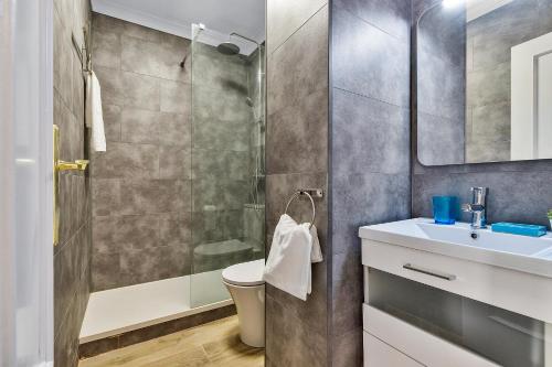 a bathroom with a shower and a toilet and a sink at Coral Apartment La Cala Beach in La Cala de Mijas