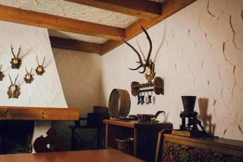 a room with antlers on the walls of a room at Pension Baranek - Baranek Resorts in Kaprun