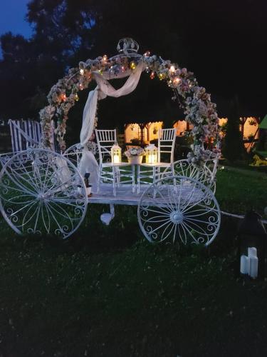 a white carriage with a table in the grass at Pensiunea Floarea Munților in Moieciu de Sus