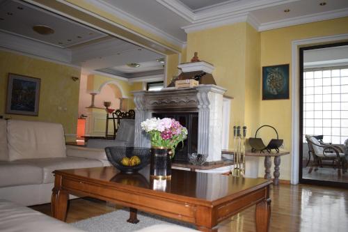 a living room with a coffee table and a fireplace at EDEN Residence in Skopje