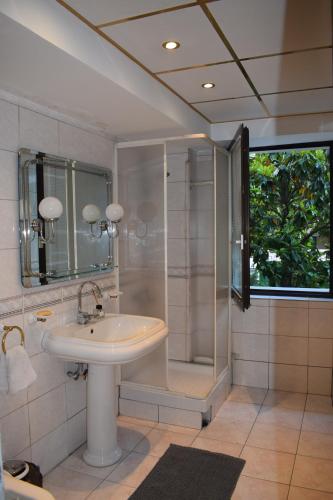 a bathroom with a sink and a shower at EDEN Residence in Skopje