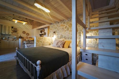 a bedroom with a bed in a room with a kitchen at TheHouse1905 in Parga